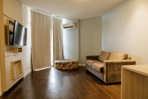 a living room with a couch and a chair at Hotel Orizzonte Niteroi by Atlantica in Niterói