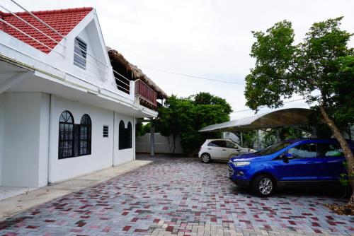 a car parked on a brick driveway in front of a house at Boca Simon Vacation Curacao in Willemstad