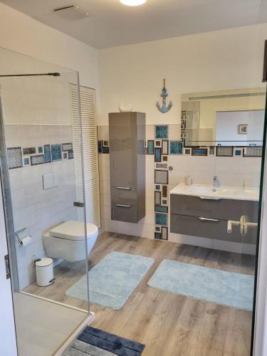 a bathroom with a shower and a toilet and a sink at private room central in Güstrow