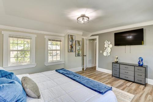 a bedroom with a large bed and a flat screen tv at 3 Mi to Dtwn Memphis Family Home in Memphis