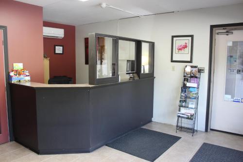 a shop with a counter with a mirror and a shelf at Bancroft Inn & Suites in Bancroft