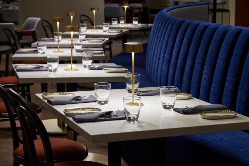 a row of tables with plates and glasses on them at The Westin Alexandria Old Town in Alexandria