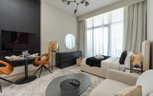 a bedroom with a bed and a living room at Nasma Luxury Stays - Azizi Riviera 6 Cozy Studio with Burj Khalifa View in Dubai