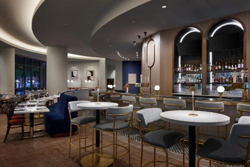 a restaurant with tables and chairs and a bar at The Westin Alexandria Old Town in Alexandria