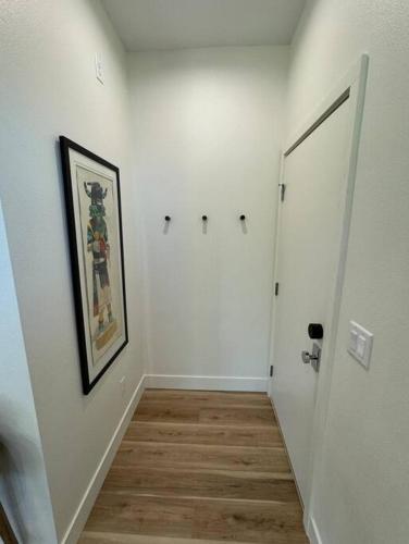 a hallway with white walls and a picture on the wall at The Loft in Salem