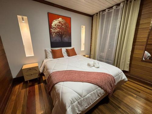 a bedroom with a bed and a large window at The Victorian Hotel in San José