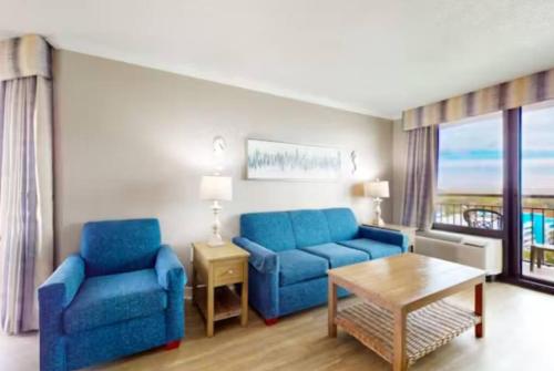 a living room with two blue chairs and a table at Your Perfect Oceanview Suite with Balcony, Dogs Ok! 1202 in Myrtle Beach