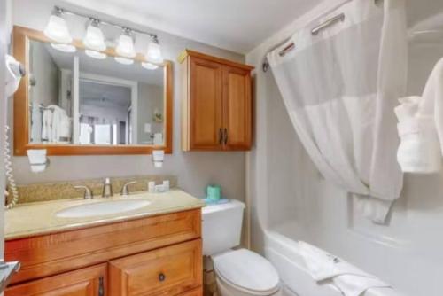 a bathroom with a sink and a toilet and a mirror at Your Perfect Oceanview Suite with Balcony, Dogs Ok! 1202 in Myrtle Beach