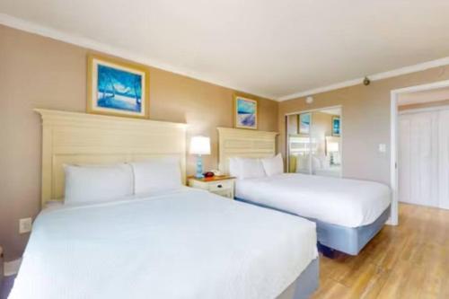 two beds in a hotel room with white sheets at Your Perfect Oceanview Suite with Balcony, Dogs Ok! 1202 in Myrtle Beach