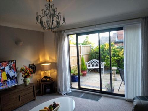 a living room with a large sliding glass door at Ludlow Mews Town House with Free parking in Ludlow