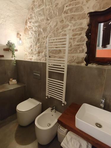 a bathroom with a white toilet and a sink at MaGia b&b Corato in Corato