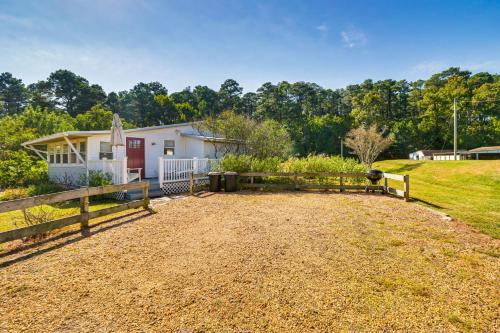 a farmhouse with a fence and a dirt yard at Walk to Beach Pet-Friendly Gem in Scotland! in Ridge
