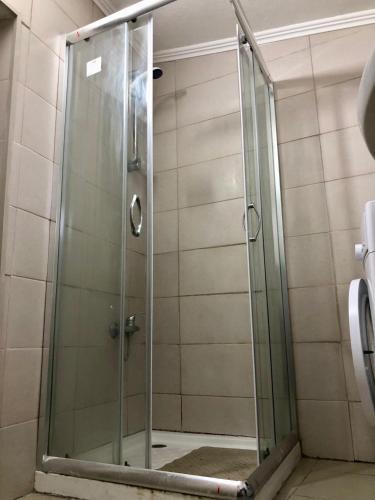 a shower with a glass door in a bathroom at Casa das Casas Novas - Beco das Avós in Elvas