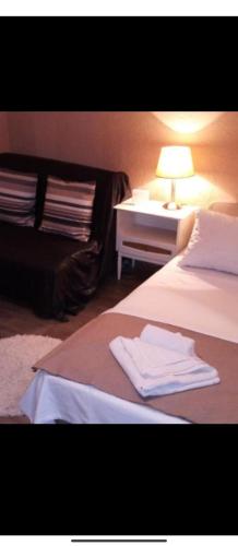a hotel room with a bed and a table with a lamp at Apartments Forest in Belgrade
