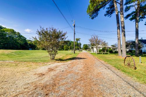 a dirt road with a tree on the side at Walk to Beach Pet-Friendly Gem in Scotland! in Ridge