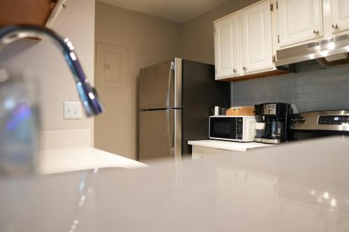 a kitchen with a stainless steel refrigerator and a microwave at Deluxe luxury & convenience in Charlotte