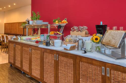 a buffet line with food and flowers on it at Tisza Balneum Hotel in Tiszafüred
