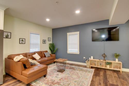 a living room with a couch and a flat screen tv at Walk to Lititz Springs Park Cozy Getaway! in Lititz