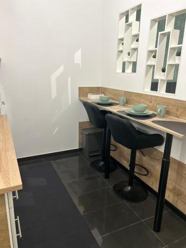a dining room with a table and two chairs at Schwarzwald City Loft in Villingen-Schwenningen