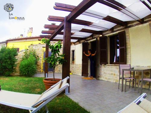 a man standing on the porch of a house at Nidastore Holidays in Arcevia
