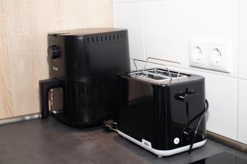 a black appliance sitting on a counter in a kitchen at GME Easy FlexHome Berlin Spandau in Berlin