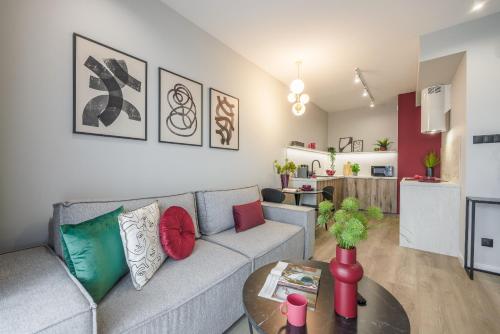 a living room with a couch and a table at Emihouse Riverside Apartments in Rzeszów