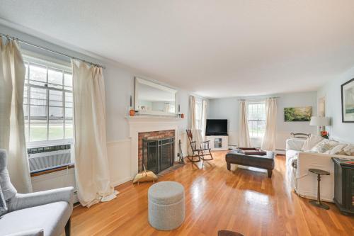 a living room with a couch and a fireplace at 10 Mi to Crane Beach Wooded Home Near Boston! in Topsfield