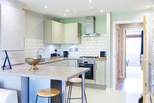 a kitchen with white cabinets and a wooden counter top at Balcony View, Fitzroy Court, 2 Bed Apartment, 2 Bathroom - High Wycombe in High Wycombe