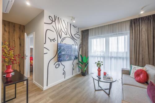 a living room with a couch and a table at Emihouse Riverside Apartments in Rzeszów