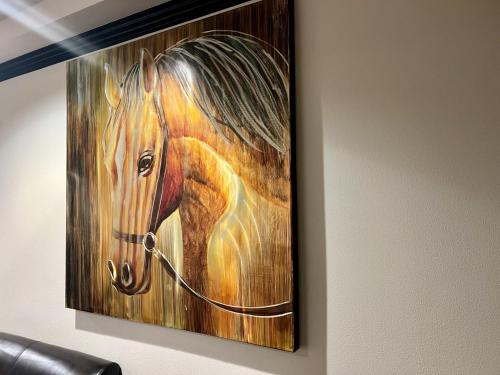 a painting of a horse hanging on a wall at Jockey Resort Suites Center Strip in Las Vegas
