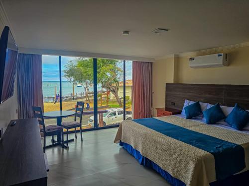 a bedroom with a bed and a view of the ocean at Plaza Lobos in Puerto Baquerizo Moreno