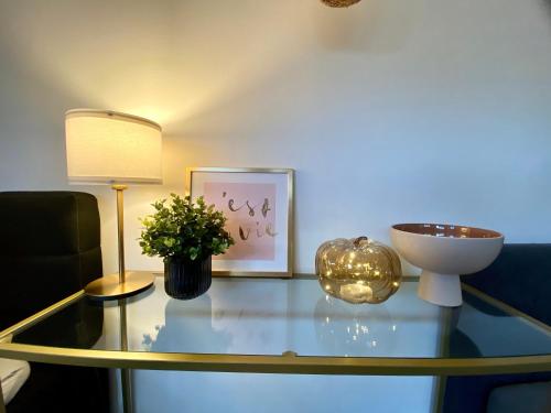 a glass table with a lamp and a plant on it at 120m2 modern 3-Bedroom Loft in Zürich in Zürich