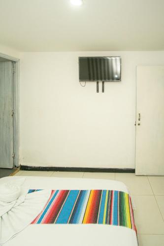 a room with a colorful rug on the floor at Hotel Playa Divina in Coveñas