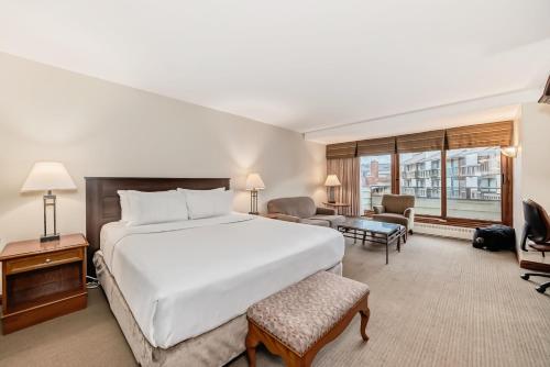 a bedroom with a large bed and a living room at Jasper Inn & Suites by INNhotels in Jasper