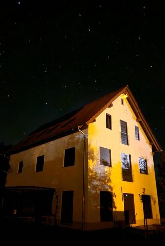 a house lit up at night with a starry sky at Traumschlösschen in Nossen