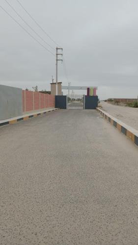 a large parking lot with a fence and a road at CycIoneda House in Piura