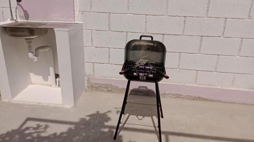 a suitcase sitting on top of a stand next to a wall at CycIoneda House in Piura