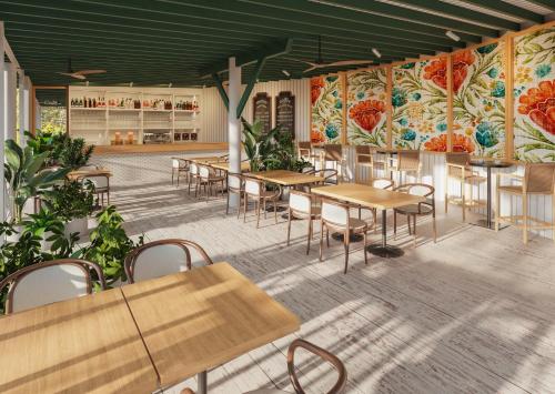 a room with tables and chairs and paintings on the walls at Secrets Saint Lucia Resort & Spa - All Inclusive in Gros Islet