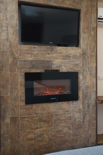 a fireplace with a television on top of it at Hotel Aqua Rio in Tijuana