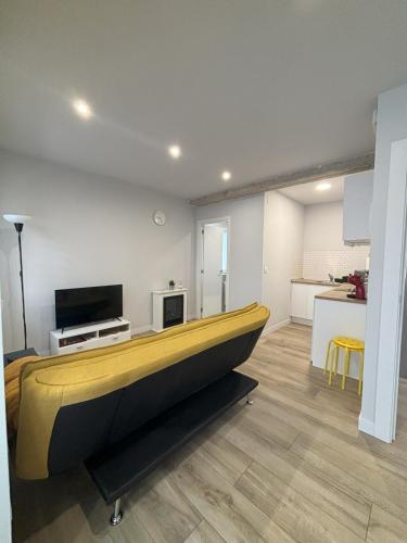 a living room with a large yellow boat in it at Apartamentos Natura Cantabria in Santillana del Mar