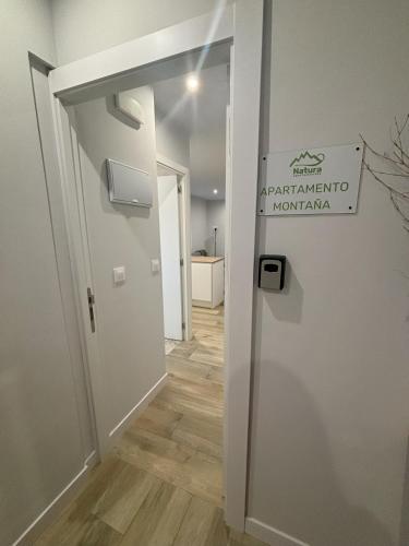 a hallway with a door leading into a room at Apartamentos Natura Cantabria in Santillana del Mar