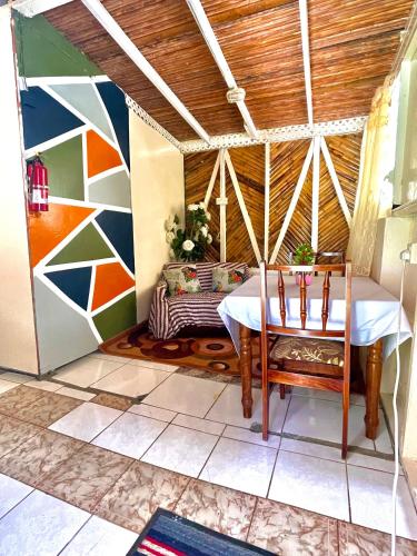 a room with a table and a bed in a room at Le Petit Paradis in Roseau