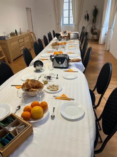 a long table with plates of food on it at Chateau Camus in Montmarault