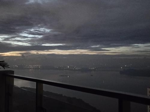 a view of the water at sunset from a balcony at Country Garden Danga Bay in Johor Bahru