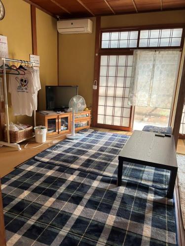 Postel nebo postele na pokoji v ubytování 汐風ライダーハウス -Shiokaze rider house-
