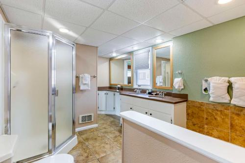 a bathroom with a shower and a sink at Best Western Sunset Inn in Cody