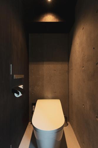 a bathroom with a white toilet in a room at momo in Kirabaru