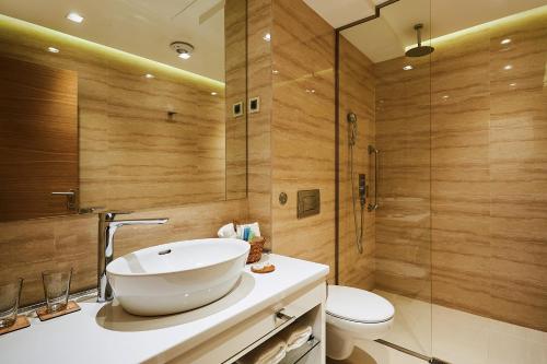 a bathroom with a sink and a toilet and a shower at One Luxury Suites in Belgrade