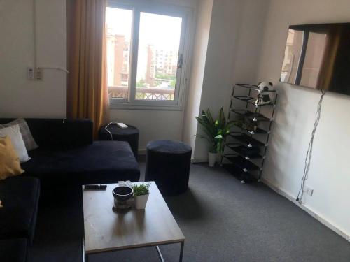 a living room with a couch and a table at Chilling home in Madinaty