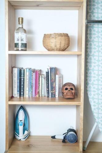 a book shelf with books and other items on it at chill green beautiful downtown area TV good Wifi in Oaxaca City